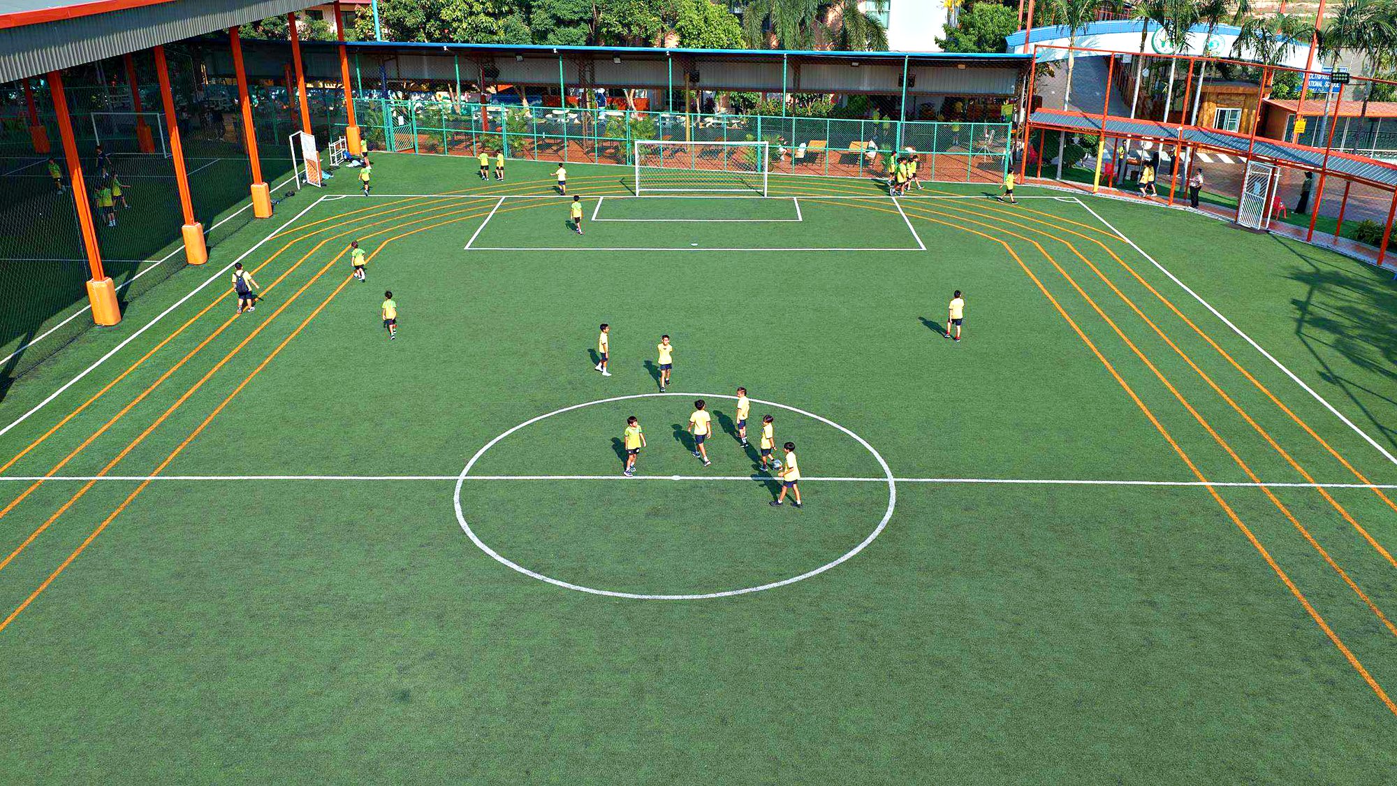 Students playing football on the pitch