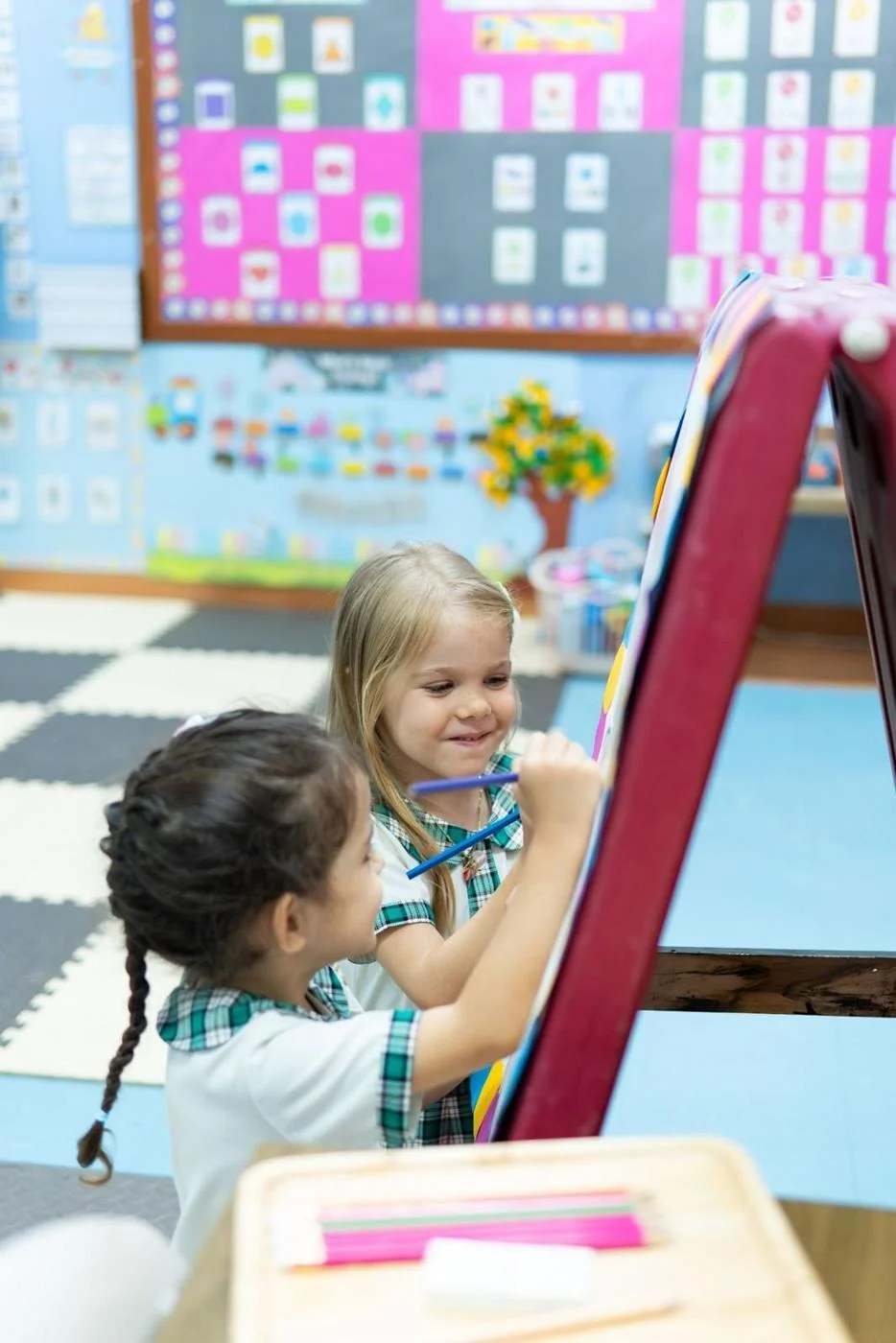Preschool 2 children counting with a teacher
