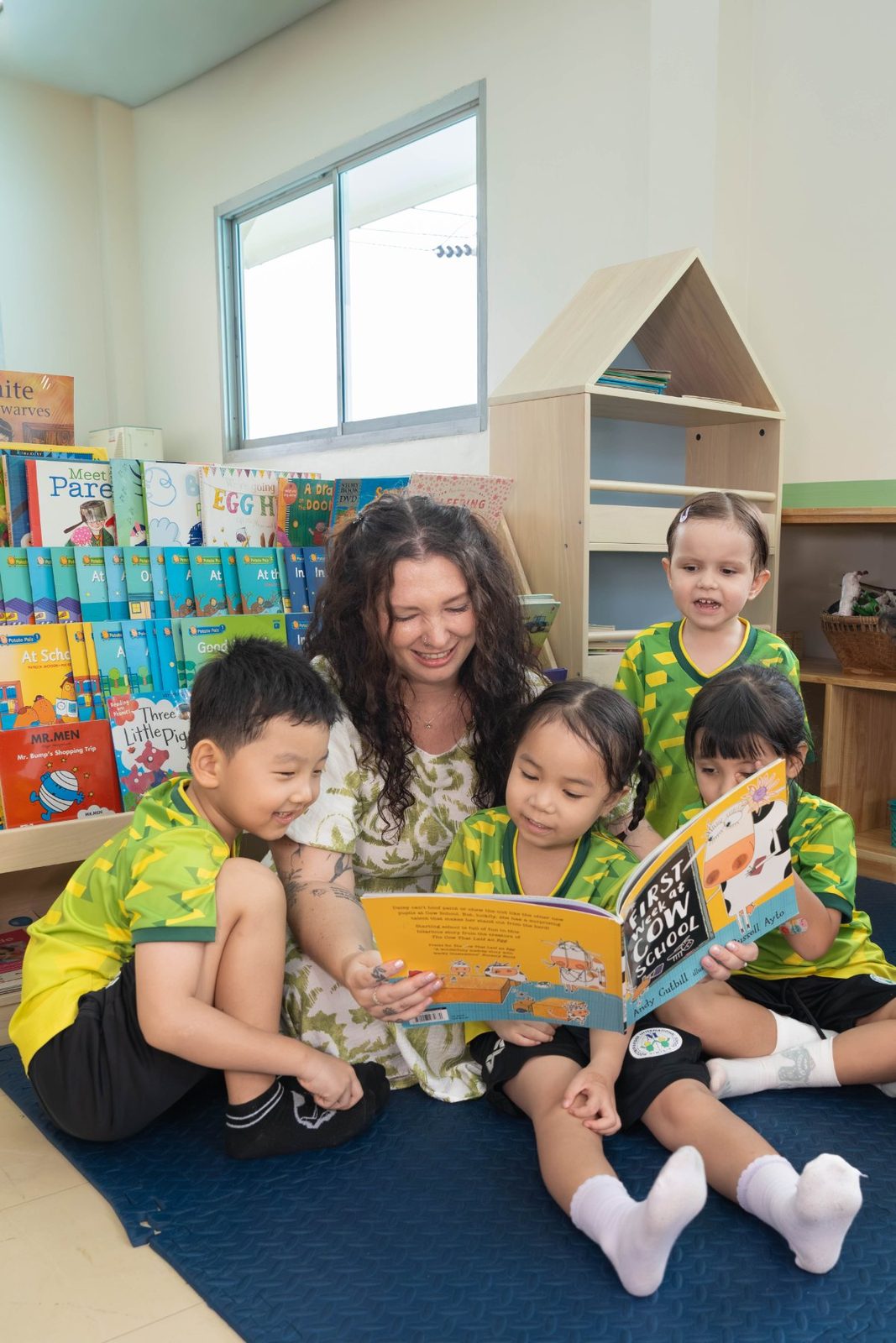 Teacher reading a picture book with a small group